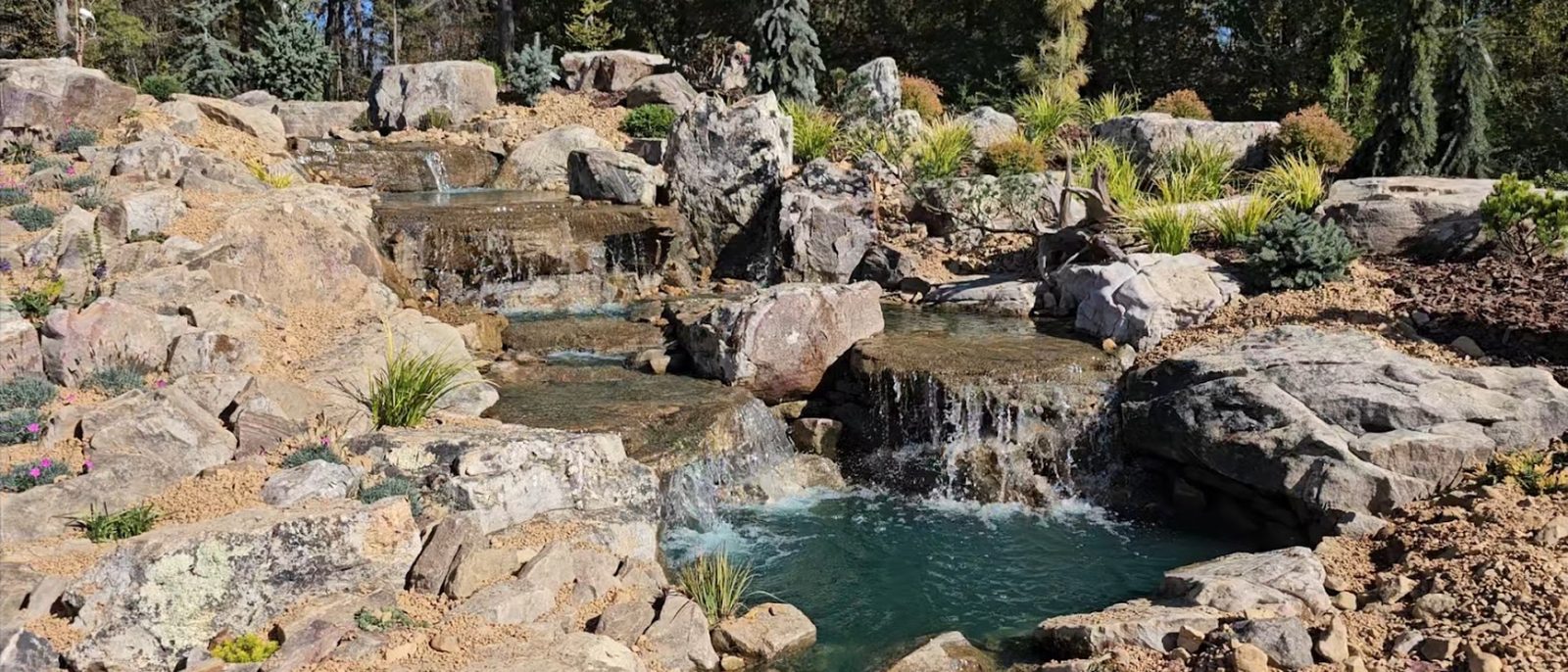 Multi-tier boulder waterfall and pond at the Unionville project