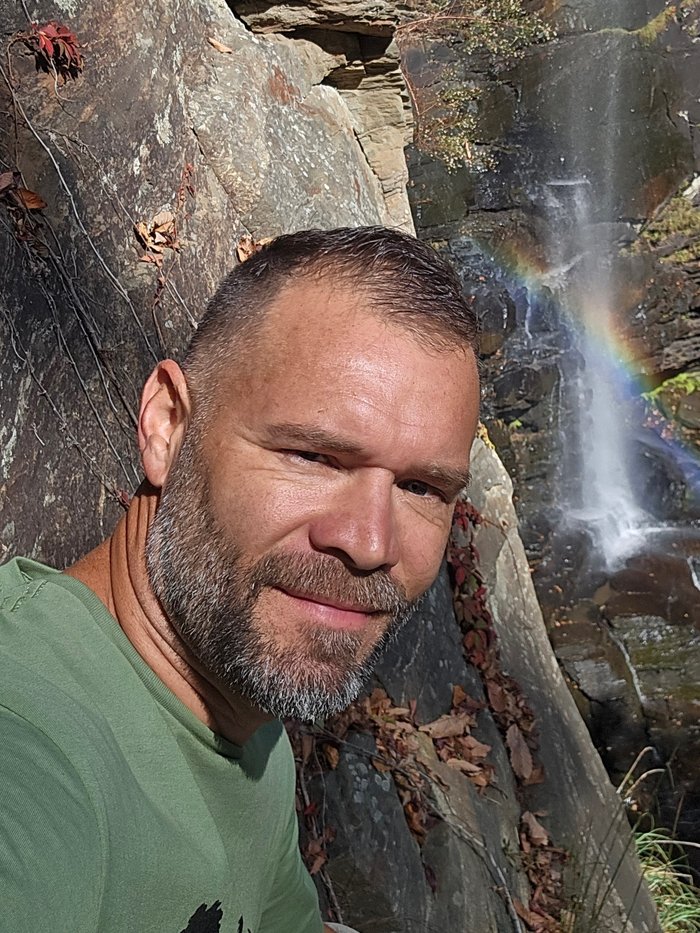 Elton Liles at a waterfall in the mountains